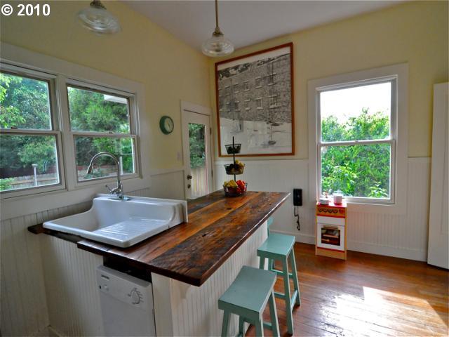 This kitchen makes no sense. The sink sits over a stairwell. 